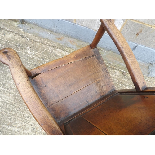 58 - An antique oak panel back chair