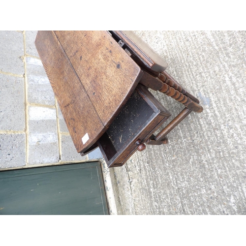 60 - An antique oak gateleg table with drawer to each end