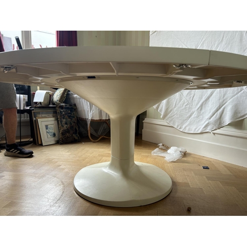 76 - A mid century circular dining table with 'trip trap' stlye extension leaves