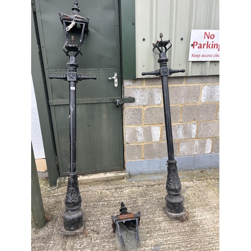 99 - A pair of iron lamp posts AF TO LANTERN TOPS