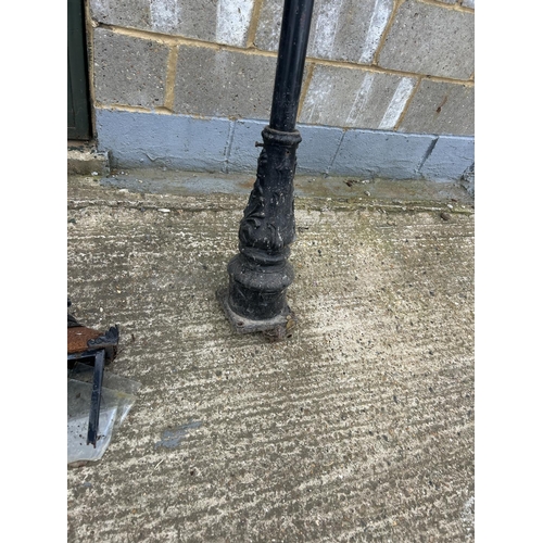 99 - A pair of iron lamp posts AF TO LANTERN TOPS