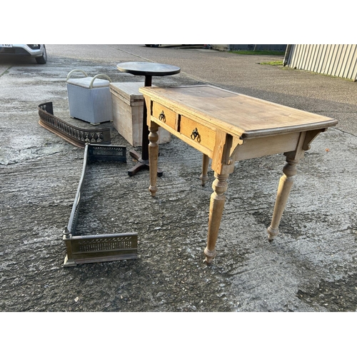 102 - An ash two drawer writing table, loom box, tea chest, occasional table and two brass fenders