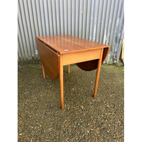 128 - A mid century teak swivel drop leaf dining table