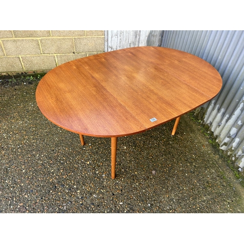 128 - A mid century teak swivel drop leaf dining table