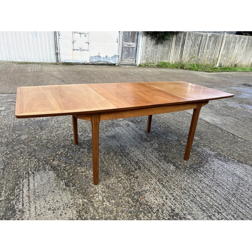 130 - A Nathan teak two leaf extending dining table 215x70x77