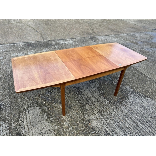 130 - A Nathan teak two leaf extending dining table 215x70x77