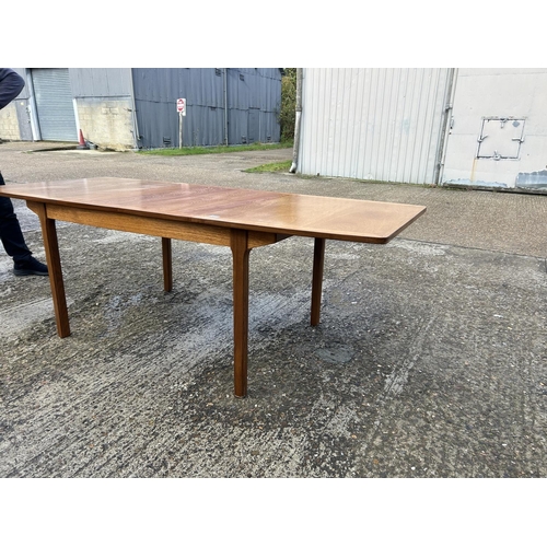 130 - A Nathan teak two leaf extending dining table 215x70x77