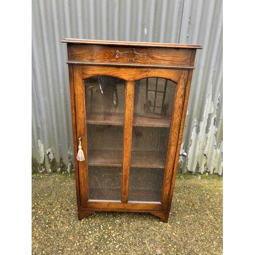 145 - An early 20th century oak cabinet with lift up top  60x24x108