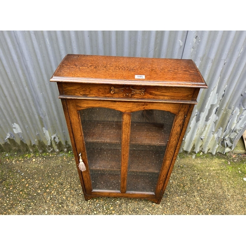 145 - An early 20th century oak cabinet with lift up top  60x24x108