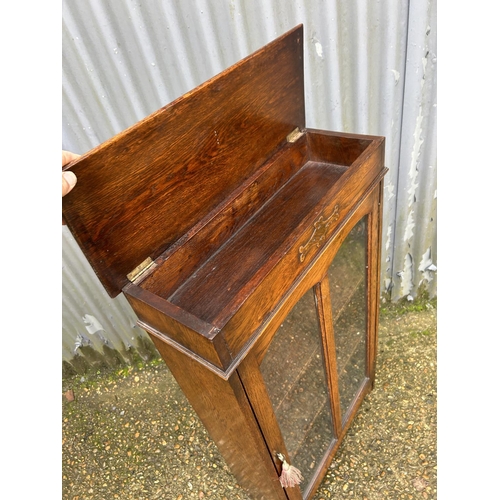 145 - An early 20th century oak cabinet with lift up top  60x24x108