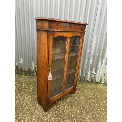 145 - An early 20th century oak cabinet with lift up top  60x24x108