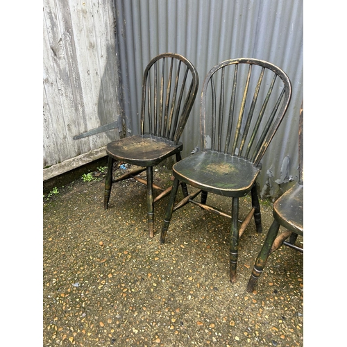 161 - A set of four country stick back kitchen chairs