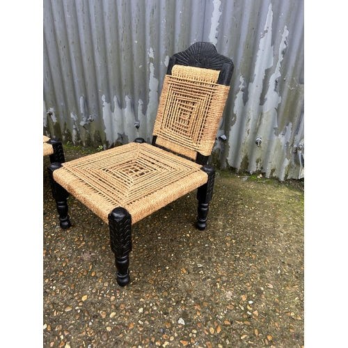 168 - A pair of african style low chairs with folding backs and cane seats