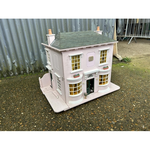 175 - A hand built dolls house furnished with furniture, fixtures and fittings 60 x50x90