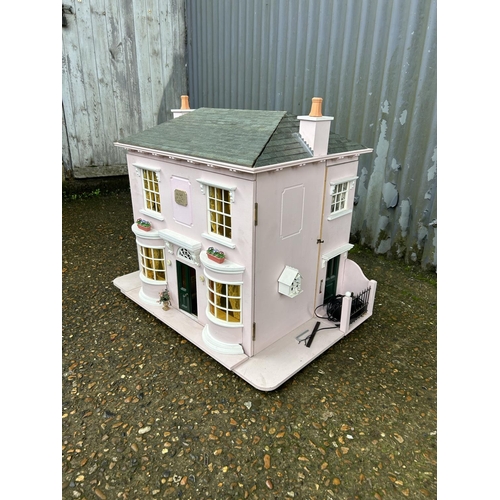 175 - A hand built dolls house furnished with furniture, fixtures and fittings 60 x50x90