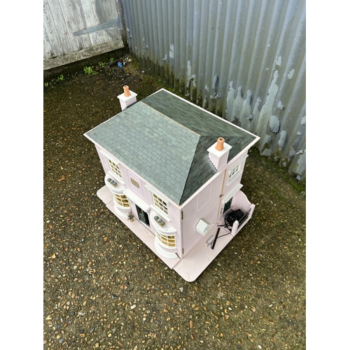 175 - A hand built dolls house furnished with furniture, fixtures and fittings 60 x50x90