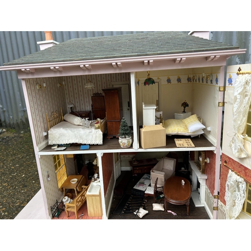 175 - A hand built dolls house furnished with furniture, fixtures and fittings 60 x50x90