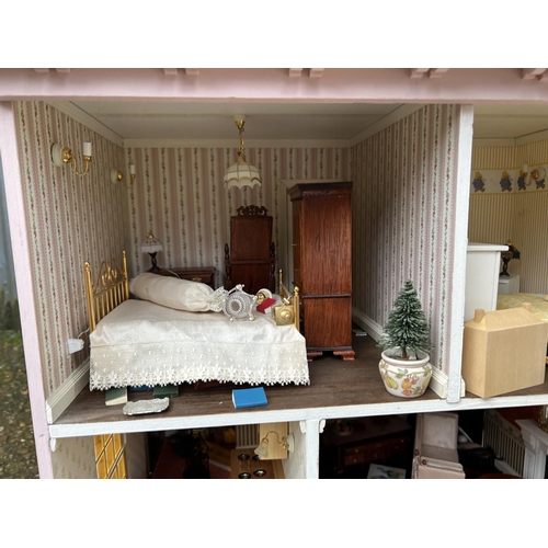 175 - A hand built dolls house furnished with furniture, fixtures and fittings 60 x50x90