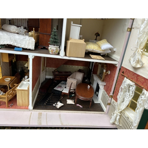 175 - A hand built dolls house furnished with furniture, fixtures and fittings 60 x50x90