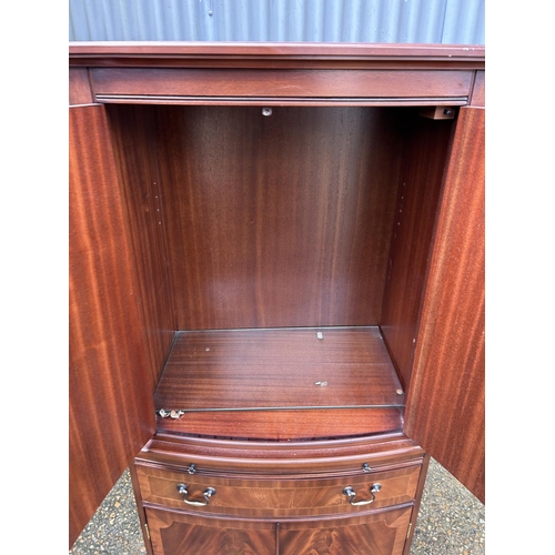 179 - A reproduction mahogany drinks cabinet