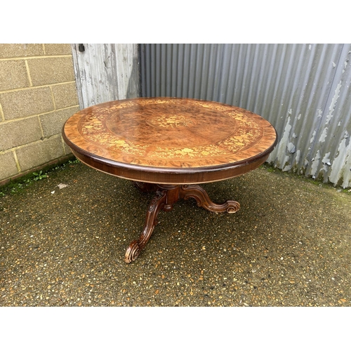 180 - A large circular inlaid dining table 130cm diameter