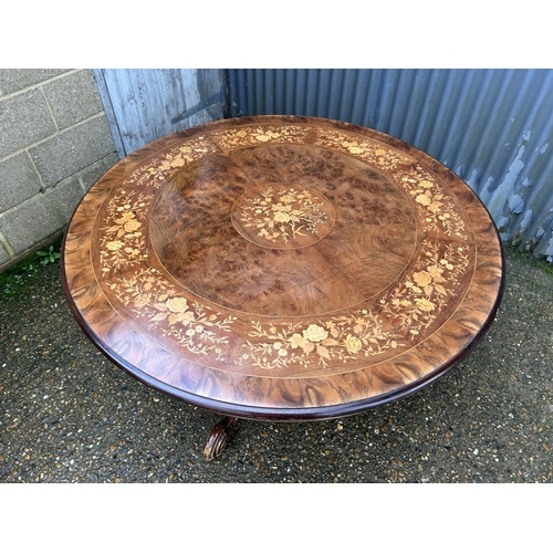 180 - A large circular inlaid dining table 130cm diameter