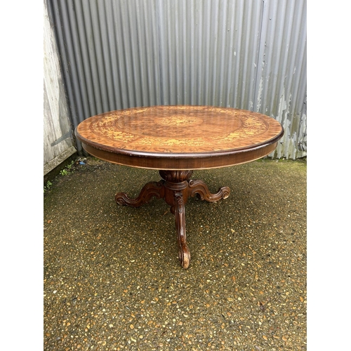 180 - A large circular inlaid dining table 130cm diameter