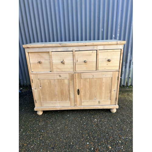 203 - A French pine sideboard with four drawers over cupboard doors  (with key) 118x38x100