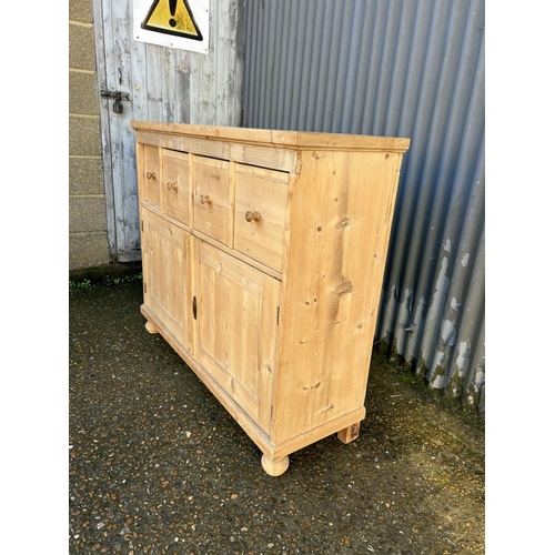 203 - A French pine sideboard with four drawers over cupboard doors  (with key) 118x38x100