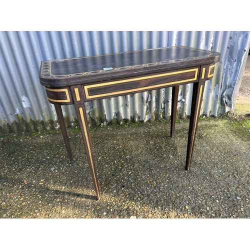 213 - A Victorian rosewood fold over tea table with gold painted decoration