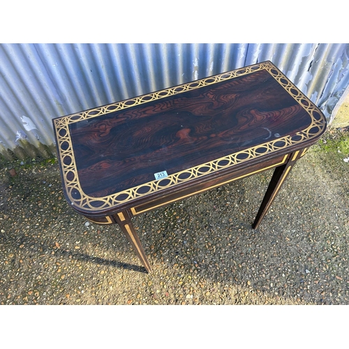 213 - A Victorian rosewood fold over tea table with gold painted decoration