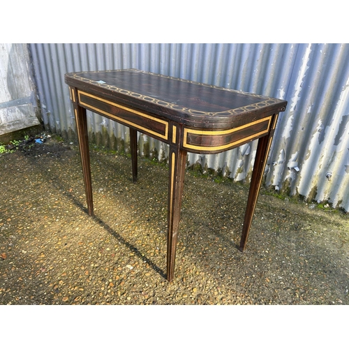 213 - A Victorian rosewood fold over tea table with gold painted decoration