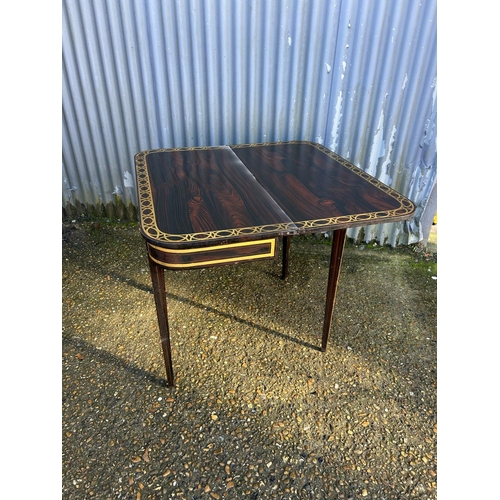 213 - A Victorian rosewood fold over tea table with gold painted decoration