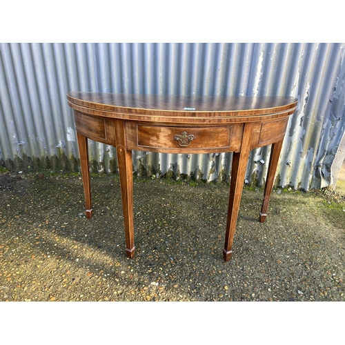 214 - A Victorian mahogany fold over card table with green baize