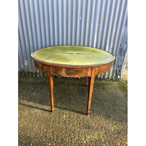 214 - A Victorian mahogany fold over card table with green baize