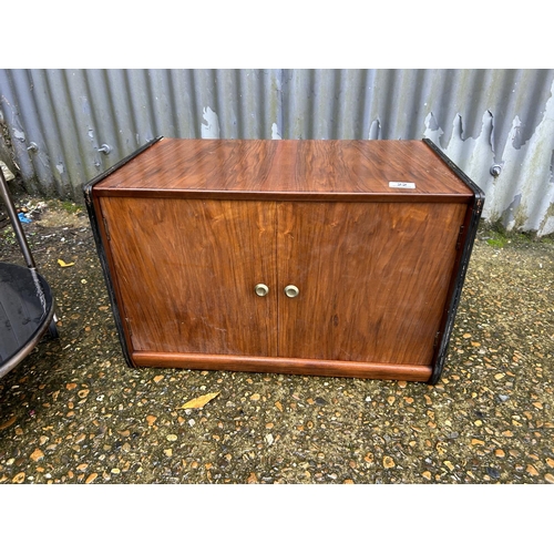 22 - A two door record cupboard together with a retro chrome circular trolley with black glass top