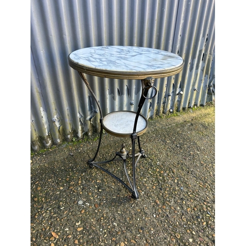 220 - A continental iron and brass framed table with white marble top 50x72