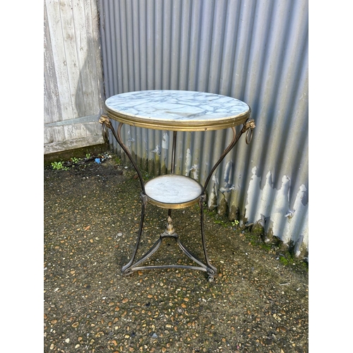 220 - A continental iron and brass framed table with white marble top 50x72