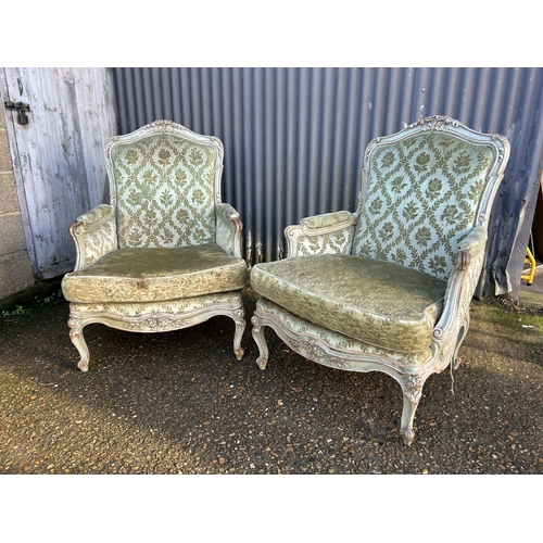 233 - A pair of green upholstered French armchairs