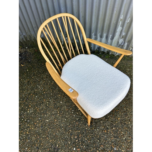 39 - An ercol light elm stick back armchair