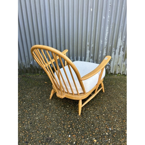 39 - An ercol light elm stick back armchair