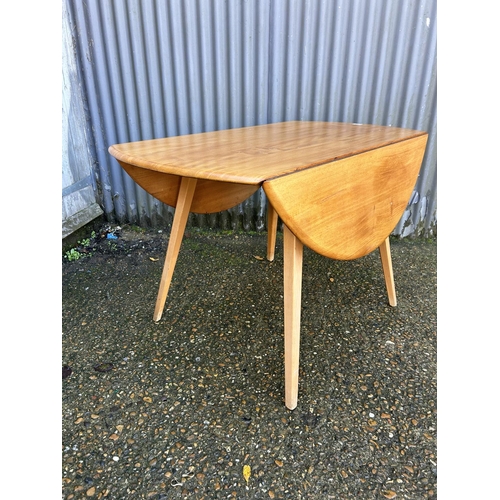 40 - An ercol light elm drop leaf kitchen table