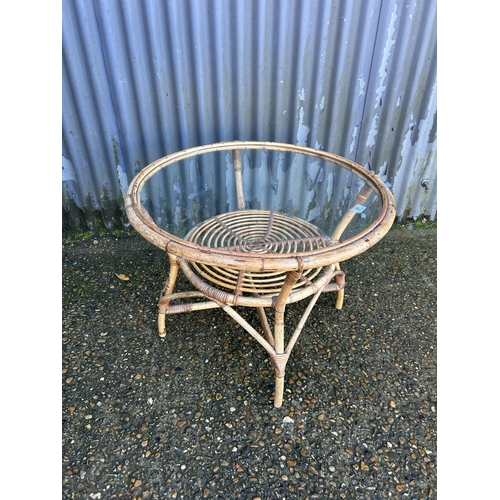 41 - A retro bamboo coffee table with glass top 70cm diameter