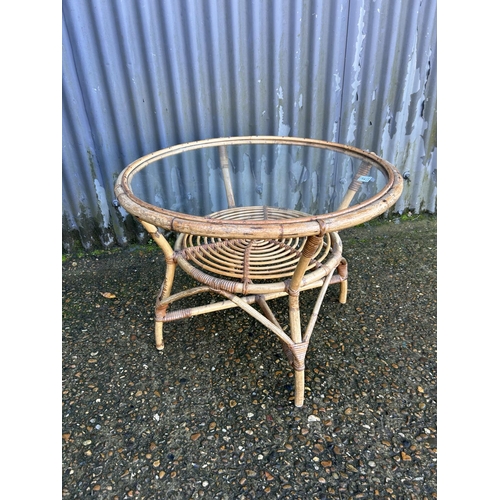 41 - A retro bamboo coffee table with glass top 70cm diameter