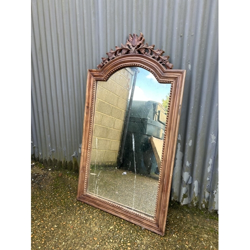 51 - An ornate carved mirror 78x140