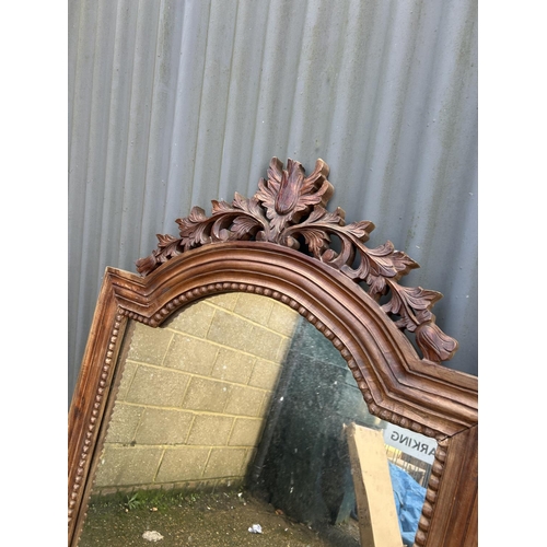 51 - An ornate carved mirror 78x140