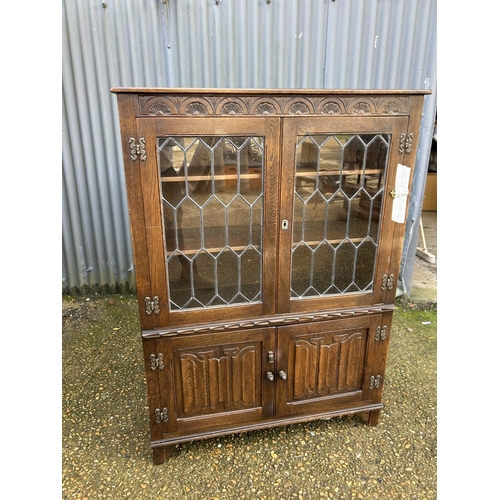 52 - A leaded oak cabinet 100x32x135