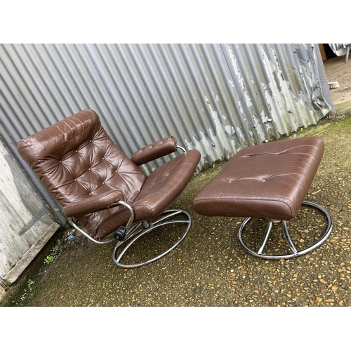 54 - A mid century chrome and brown leather reclining chair and stool