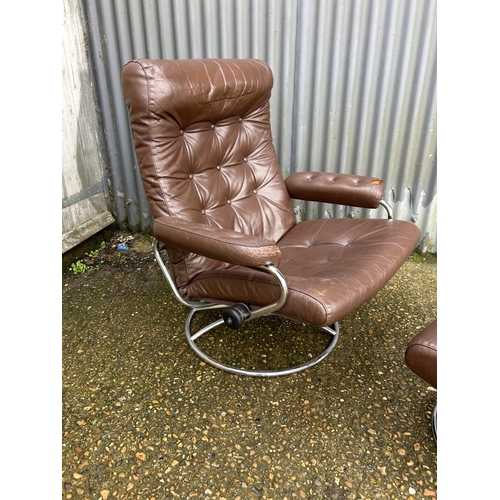 54 - A mid century chrome and brown leather reclining chair and stool