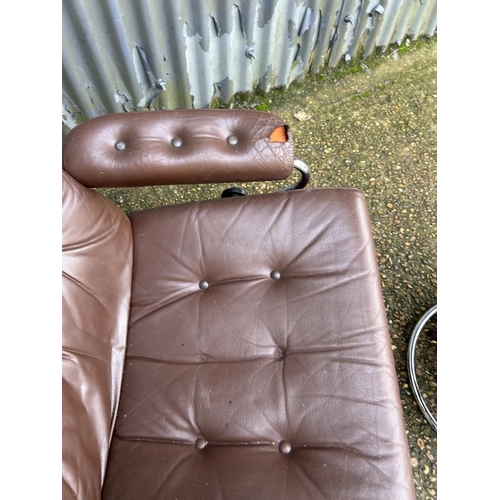 54 - A mid century chrome and brown leather reclining chair and stool